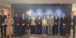 Autoridades posam para a foto. Atrás delas, uma parede azul com a inscrição Tribunal Regional El...